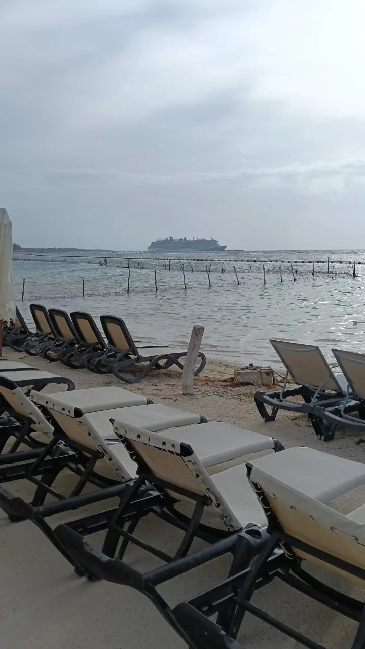Beach loungers facing the sea at the Mahahual beach club