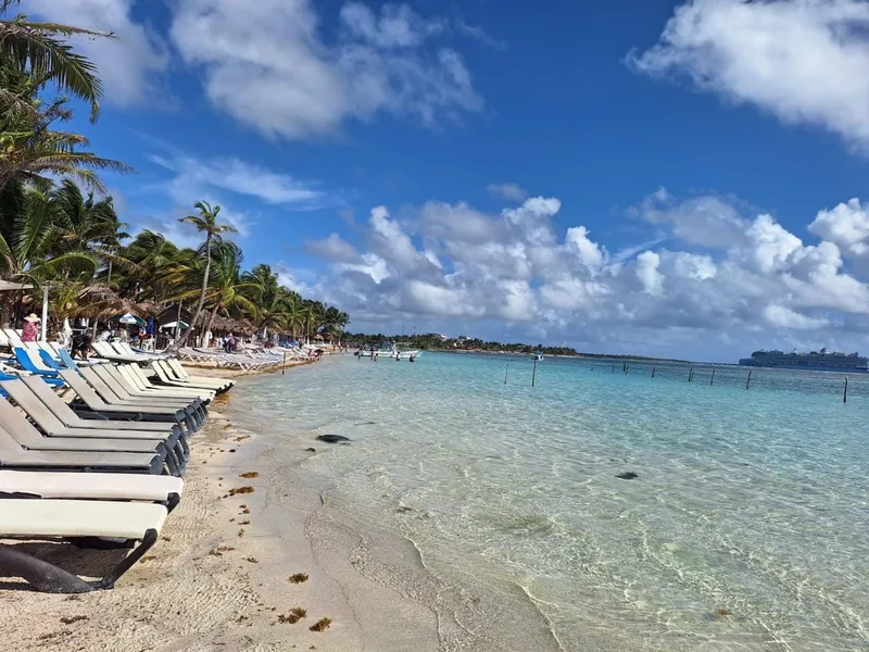 Turquoise Caribbean water and sun loungers at our Mahahual beach club
