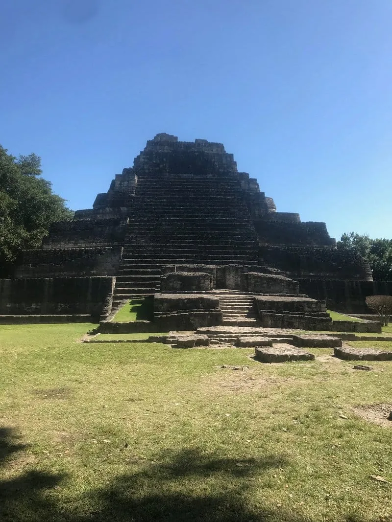 The great pyramid of Chacchoben under a deep blue sky