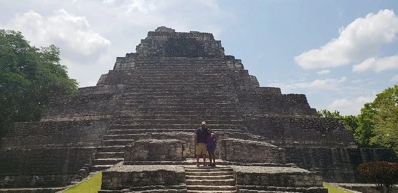 Visitor standing on the steps of the Chacchoben pyramid