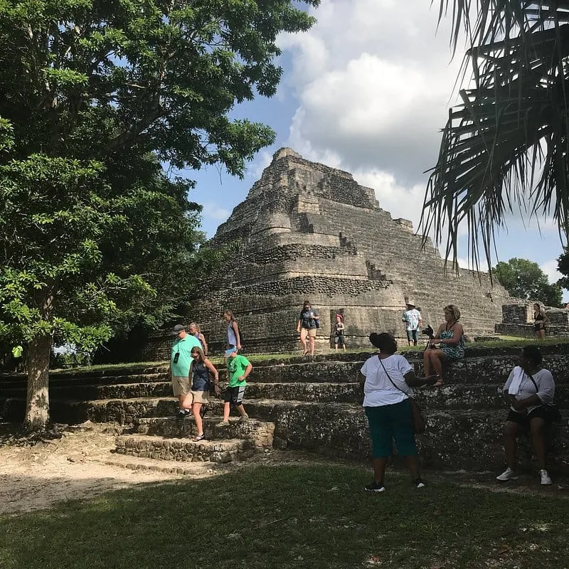Tour group climbing the steps of the Chacchoben pyramid