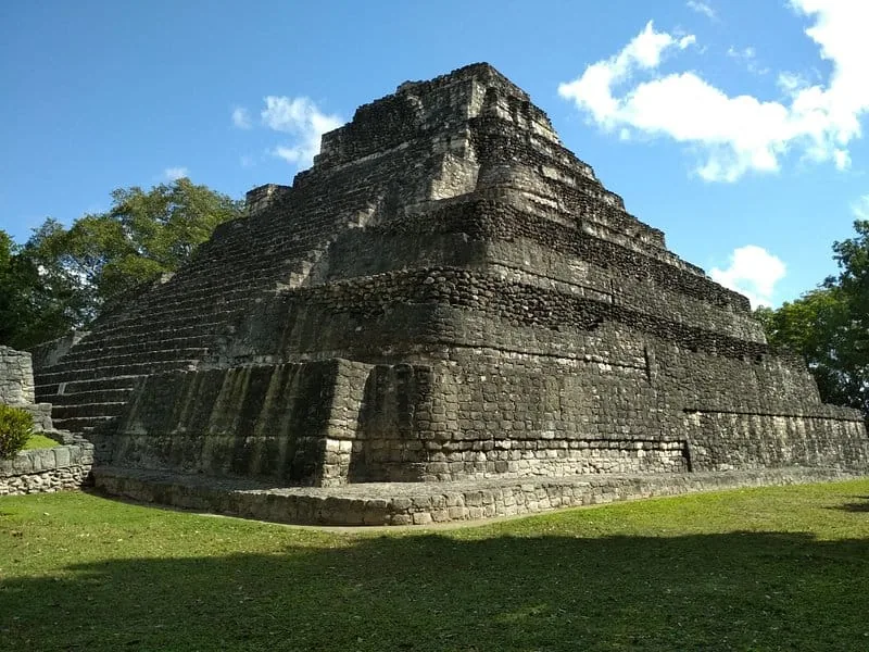 The main temple of Chacchoben framed by blue sky and clouds
