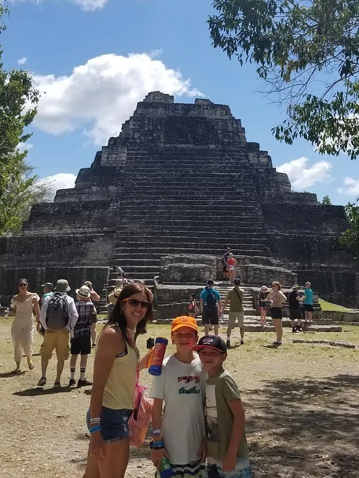 Family posing in front of the Chacchoben pyramid on our tour