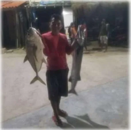 Crew member with the catch of the day on Mahahual beach