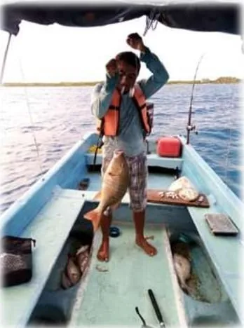 Guest fishing from our panga boat off the coast of Mahahual