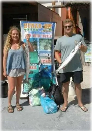 Guests at our tour stand in Mahahual after their fishing trip
