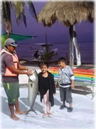 Family with their catch after a deep sea fishing tour in Costa Maya