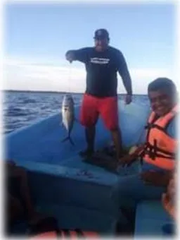 Captain and guest with a tuna on the fishing boat in Mahahual