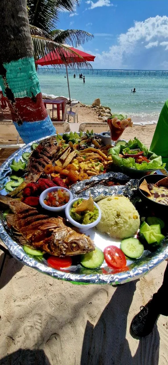 Grilled seafood platter with rice, guacamole and salad served facing the Caribbean