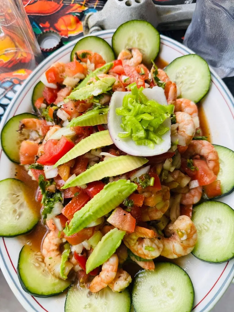 Shrimp ceviche with avocado, cucumber and tomato served fresh on the beach